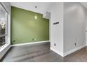 Simple dining area with green accent wall and hardwood floors at 1927 Eaton St, Lakewood, CO 80214