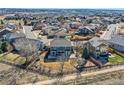 Home aerial showing fenced yard with mature trees and landscaping, close to neighborhood amenities at 16333 Prairie Farm Cir, Parker, CO 80134