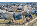 Aerial view of the home's backyard with mature trees, nice landscaping and view of a playground set at 16333 Prairie Farm Cir, Parker, CO 80134