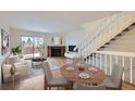 Open living and dining area with a fireplace and access to a patio at 11167 W 17Th Ave # 104, Lakewood, CO 80215
