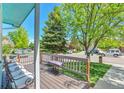 Cozy front porch with seating, offering a relaxing outdoor space with views of the neighborhood at 12333 Newport Ct, Brighton, CO 80602