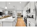 Bright, open-concept kitchen with an island, modern appliances, and sleek countertops at 4027 E 98Th Pl, Thornton, CO 80229