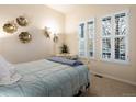 Bright bedroom with natural light from shuttered windows and stylish decor at 5377 Cloverbrook Cir, Highlands Ranch, CO 80130