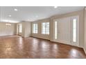 Bright living room with large windows and a welcoming front door at 1038 Tenderfoot Dr, Larkspur, CO 80118