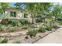 Attractive home featuring a well-manicured lawn and landscaping, with stepping stones to entrance at 1080 Ithaca Dr, Boulder, CO 80305