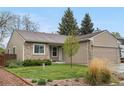 Inviting single-story home with a well-kept lawn and mature landscaping at 9960 Garland Ln, Broomfield, CO 80021