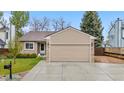 Charming single-Gathering home featuring a well-manicured lawn and attached two car garage at 9960 Garland Ln, Broomfield, CO 80021