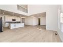 Open-concept living space with light wood floors, white walls, and recessed lighting at 907 Congress Pl, Elizabeth, CO 80107