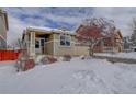 Charming single-Gathering home featuring a covered front porch and snow-covered front yard at 4211 Miners Candle Pl, Castle Rock, CO 80109