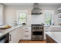 Bright kitchen featuring marble countertops, white cabinetry, stainless steel appliances, and a Viking range at 401 S Williams St, Denver, CO 80209