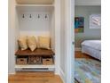 Convenient mudroom featuring built-in storage, bench, and decor with hardwood floors at 401 S Williams St, Denver, CO 80209