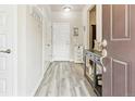 Bright entryway featuring wood-look flooring, a white front door, and a stylish console table as you enter at 2395 S Troy Ct, Aurora, CO 80014