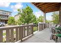 Inviting covered front porch featuring a concrete floor, wood ceiling, and cozy seating area to enjoy outdoor living at 2395 S Troy Ct, Aurora, CO 80014
