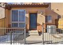 Townhouse front entrance with walkway and fence at 4452 S Auckland Ct, Aurora, CO 80015