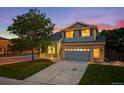 Charming two-story home boasts a well-maintained lawn and an attached two-car garage at 5796 E 129Th Pl, Thornton, CO 80602