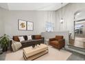 Cozy living room with high ceilings, modern decor, and plenty of natural light at 5796 E 129Th Pl, Thornton, CO 80602