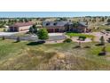 Sprawling home on a large lot with beautiful landscaping and green lawns, attached garage and a separate barn at 11624 Dunrich Rd, Parker, CO 80138