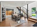 Dining room with modern staircase, black framed windows and a modern table at 1612 Wolff St, Denver, CO 80204