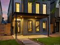 Close up of the front exterior with walkway and covered porch of a modern-style home at 1612 Wolff St, Denver, CO 80204