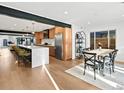 Spacious, open-concept kitchen and dining area with island seating and modern appliances at 1612 Wolff St, Denver, CO 80204