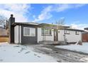Newly remodeled ranch home exterior with snowy yard at 9300 Grove St, Westminster, CO 80031