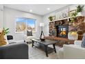 Living room with stone fireplace and comfy seating at 9300 Grove St, Westminster, CO 80031