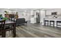 Open floor plan with stone fireplace, kitchen island, and gray sofa at 9300 Grove St, Westminster, CO 80031