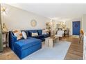 Cozy living room featuring a stylish blue sectional sofa, hardwood floors, and modern decor at 2 N Adams St # 108, Denver, CO 80206
