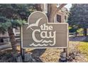 Community sign for The Cay surrounded by lush greenery at 8378 S Upham Way # B305, Littleton, CO 80128