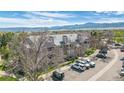 Apartment building exterior with balconies, trees, and parking in a well maintained community at 8378 S Upham Way # B305, Littleton, CO 80128