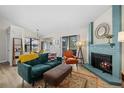 Bright living room featuring modern decor, a fireplace, and balcony access at 8378 S Upham Way # B305, Littleton, CO 80128