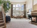 Bright, spacious living room with a large window, fireplace, and comfortable seating arrangement at 7858 Oban Ct, Lone Tree, CO 80124