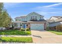 Charming two-story home with a well-manicured lawn and a two-car garage at 6317 Ruby Hill Dr, Erie, CO 80516