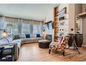 Bright living room featuring hardwood floors, a fireplace, and large windows with natural light at 13495 Shiloh Rd, Conifer, CO 80433