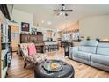 Open-concept living space with hardwood floors seamlessly connects to the kitchen and dining areas at 13495 Shiloh Rd, Conifer, CO 80433