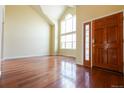Inviting foyer with hardwood floors and a bright, high-ceiling window at 18112 E Dorado Ave, Centennial, CO 80015
