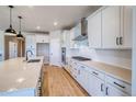Bright kitchen with white cabinets, stone countertops, and stainless steel appliances at 680 Tubman Dr, Elizabeth, CO 80107