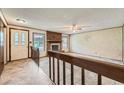 View of a spacious living room featuring a cozy brick fireplace and ample natural light at 1431 S Chambers Cir, Aurora, CO 80012