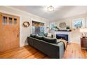 Inviting living room featuring hardwood floors, a cozy fireplace, and a comfortable sofa for relaxation at 4135 Hooker St, Denver, CO 80211