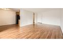 Bright living room featuring wood-look floors, ample space, and an entrance door, offering a welcoming atmosphere at 2325 S Linden Ct # 201, Denver, CO 80222