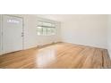 Bright living room with hardwood floors, a large window, and fresh paint at 5669 Johnson Ct, Arvada, CO 80002