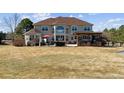 Expansive backyard featuring a spacious patio, outdoor seating, lush lawn, and a pergola for entertaining at 391 High Ridge Way, Castle Pines, CO 80108