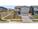 Corner lot property shows landscaped yard, well-maintained lawn, and convenient two-car garage at 9196 Rifle St, Commerce City, CO 80022