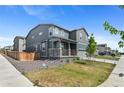 This home shows a well-manicured lawn, and a two-car garage in a desirable community at 9196 Rifle St, Commerce City, CO 80022