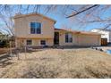 Split level home featuring an attached one car garage, lawn, and windows with white shutters at 1123 S Biscay St, Aurora, CO 80017