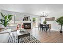 Bright living room with a fireplace, wood floors, and a sliding door to the backyard at 1203 S Zeno Way # B, Aurora, CO 80017