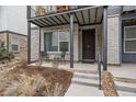 Charming front porch with a seating area, providing a welcoming entrance to the home at 5189 Vivian St, Wheat Ridge, CO 80033