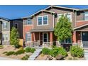 Inviting two-story home with landscaped front yard and covered porch entry at 13711 Ash Cir, Thornton, CO 80602