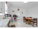 Functional kitchen with classic black and white flooring, appliances, and a cozy dining area at 14798 N 115Th St, Longmont, CO 80504