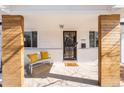 Inviting front porch with comfortable seating and stylish decorative wood columns at 3180 S Albion St, Denver, CO 80222